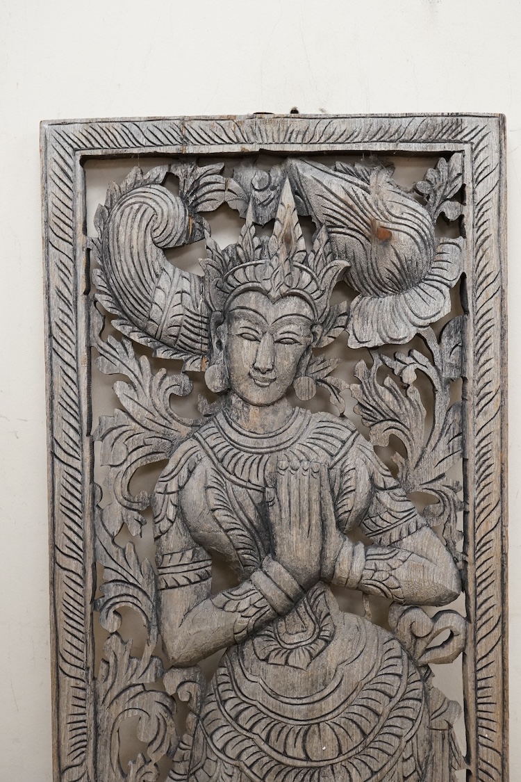 An Asian or Thai carved panel of a deity, 90cm high